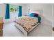 Bright bedroom features a window with a view, carpet, and white walls at 1323 Valley E Hl, Lakeland, FL 33813