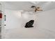 Open room with an oversized chair, neutral color palette, fan, and carpet flooring at 1323 Valley E Hl, Lakeland, FL 33813