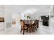 Dining room features a large wooden table with ornate chairs, a modern chandelier, and a skylight at 1323 Valley E Hl, Lakeland, FL 33813