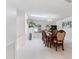 Bright dining room has an ornate dining table set, a skylight, and modern chandelier at 1323 Valley E Hl, Lakeland, FL 33813