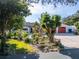 Charming home with lush landscaping, mature trees, and well-maintained lawn, creating a welcoming curb appeal at 1323 Valley E Hl, Lakeland, FL 33813