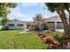 Inviting single-story home featuring fresh landscaping and a two-car garage, complemented by a well-manicured lawn at 1323 Valley E Hl, Lakeland, FL 33813