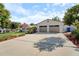 Spacious two-car garage with an expansive driveway, enhanced by colorful garden landscaping at 1323 Valley E Hl, Lakeland, FL 33813