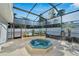 Enjoy the spa in a screened-in patio with lush landscaping at 1323 Valley E Hl, Lakeland, FL 33813
