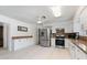 Kitchen features white cabinetry, stainless steel appliances, white countertops, and a ceiling fan at 1323 Valley E Hl, Lakeland, FL 33813