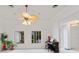 Bright living room boasts high ceilings, tropical fan, and ample natural light from large windows at 1323 Valley E Hl, Lakeland, FL 33813
