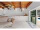 Living room with light colored chaise lounge, decorative lighting, and a sliding glass door to the pool at 1323 Valley E Hl, Lakeland, FL 33813