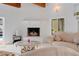 Chic living room boasts a white brick fireplace, cozy seating, and a view to the outdoor pool at 1323 Valley E Hl, Lakeland, FL 33813