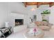 Bright living room features a white brick fireplace, light colored walls, and decorative glass table at 1323 Valley E Hl, Lakeland, FL 33813