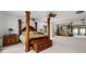This spacious main bedroom offers a four-poster bed, and a full wall mirror at 1323 Valley E Hl, Lakeland, FL 33813
