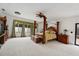 This spacious main bedroom features a large window and a stylish four-poster bed at 1323 Valley E Hl, Lakeland, FL 33813