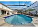 A refreshing screened-in pool with blue tiles and a spacious surrounding patio at 1323 Valley E Hl, Lakeland, FL 33813