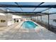 Enclosed pool area with bright blue water and white stone deck surrounded by a black metal fence, providing a private oasis at 1323 Valley E Hl, Lakeland, FL 33813