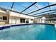 Inviting in-ground pool enclosed by a screened lanai, offering a refreshing escape in a private setting at 1323 Valley E Hl, Lakeland, FL 33813