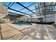 A covered pool featuring an outdoor stone deck and a screened-in enclosure at 1323 Valley E Hl, Lakeland, FL 33813