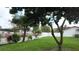 A well-maintained yard with a mix of mature trees, shrubs, and a white picket fence at 1323 Valley E Hl, Lakeland, FL 33813