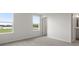 Bright bedroom with plush carpeting, neutral walls, and double windows offering natural light and a view at 305 Wharf Way, Winter Haven, FL 33881