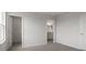 A bright bedroom featuring neutral decor, plush carpeting, and doorways leading to the closet and bathroom at 305 Wharf Way, Winter Haven, FL 33881