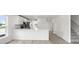 Well-lit kitchen boasts marble countertop, stainless steel appliances, and an adjacent staircase at 305 Wharf Way, Winter Haven, FL 33881