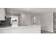 Modern kitchen with white cabinets, stainless appliances, and an eat-in marble countertop at 305 Wharf Way, Winter Haven, FL 33881