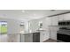 Modern kitchen featuring marble countertops, stainless steel appliances, and an open layout at 305 Wharf Way, Winter Haven, FL 33881