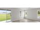 Bright, airy living area with wood floors and sliding glass doors with backyard view at 305 Wharf Way, Winter Haven, FL 33881
