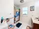 Bathroom featuring a shower with an ocean-themed shower curtain, a matching toilet seat, and natural light at 309 W Frederick Ave, Dundee, FL 33838
