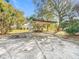 Open carport with a lawn mower underneath and ample space for parking at 309 W Frederick Ave, Dundee, FL 33838