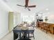 Open dining room with dark wood table and chairs, a decorative hutch, and views to the kitchen and living room at 309 W Frederick Ave, Dundee, FL 33838
