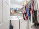 Functional laundry room equipped with a washer, dryer, shelving, and ample storage space for cleaning supplies at 309 W Frederick Ave, Dundee, FL 33838