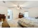 Bedroom featuring carpet, a ceiling fan, and an ensuite bathroom with ample natural light at 309 W Frederick Ave, Dundee, FL 33838