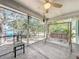 Relaxing screened porch with a porch swing overlooking a serene outdoor view and peaceful seating at 309 W Frederick Ave, Dundee, FL 33838