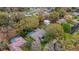 Aerial shot of a charming home with a private backyard pool in a lush, tree-filled neighborhood at 3845 Garnet Dr, Mulberry, FL 33860