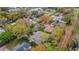 Overhead view of a cozy house nestled amongst mature trees in a quiet residential neighborhood at 3845 Garnet Dr, Mulberry, FL 33860
