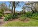 Lush backyard featuring mature trees, landscape beds and privacy at 3845 Garnet Dr, Mulberry, FL 33860