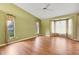 Bright bedroom featuring hardwood floors, neutral walls, and large windows at 3845 Garnet Dr, Mulberry, FL 33860