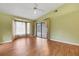 Bright and spacious bedroom featuring hardwood floors, a fan, and pool access at 3845 Garnet Dr, Mulberry, FL 33860