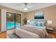 Bedroom with sliding glass door leading to pool and decorated with a rug, art and lamps at 3845 Garnet Dr, Mulberry, FL 33860