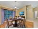 Dining area featuring hardwood floors, decorative rug, seating for four, and stylish decor at 3845 Garnet Dr, Mulberry, FL 33860