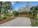 Charming single-story home featuring a well-manicured front yard with lush landscaping and a spacious driveway at 3845 Garnet Dr, Mulberry, FL 33860