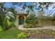 Charming home exterior with well-manicured landscaping and arched doorway at 3845 Garnet Dr, Mulberry, FL 33860
