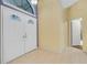 Bright foyer featuring double entry doors, neutral tile flooring, and plenty of space at 3845 Garnet Dr, Mulberry, FL 33860