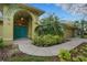 Inviting front entrance featuring turquoise double doors and lush landscaping at 3845 Garnet Dr, Mulberry, FL 33860