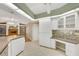 Spacious kitchen boasts white cabinets, tiled floors, and a built-in workstation at 3845 Garnet Dr, Mulberry, FL 33860