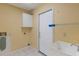Functional laundry room with utility sink, storage cabinet, and access door at 3845 Garnet Dr, Mulberry, FL 33860