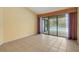 Inviting living room featuring tiled floors and sliding glass doors to the pool at 3845 Garnet Dr, Mulberry, FL 33860