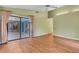 Spacious living room featuring wood floors, a ceiling fan, and a glass sliding door to the lanai at 3845 Garnet Dr, Mulberry, FL 33860