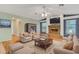 Staged living room with brick fireplace, hardwood floors, and seating arrangement at 3845 Garnet Dr, Mulberry, FL 33860