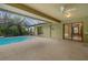 Enjoy outdoor living on this covered patio overlooking the pool and lush backyard at 3845 Garnet Dr, Mulberry, FL 33860