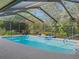 Relax in this in-ground pool enclosed in a screened-in lanai with ample privacy at 3845 Garnet Dr, Mulberry, FL 33860
